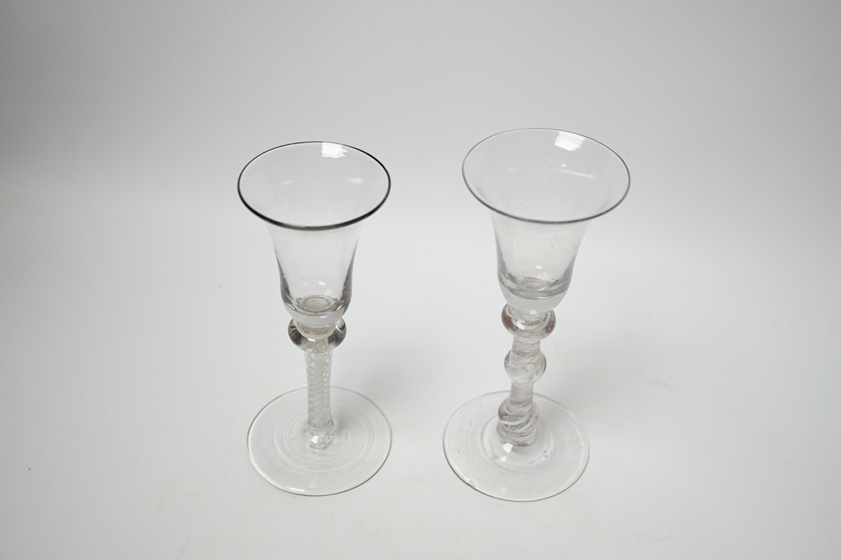 Two Dutch DSOT stem glasses, with bell-shaped bowls, one with three knops, the other with one knop at the top of the stem, tallest 17cm